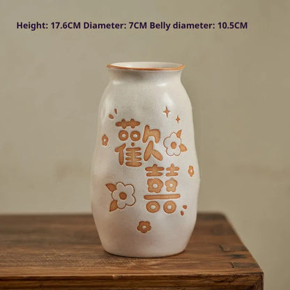 Hand-painted Chinese ceramic vase with carved detail on a desk, shown in Double Happiness colour design.