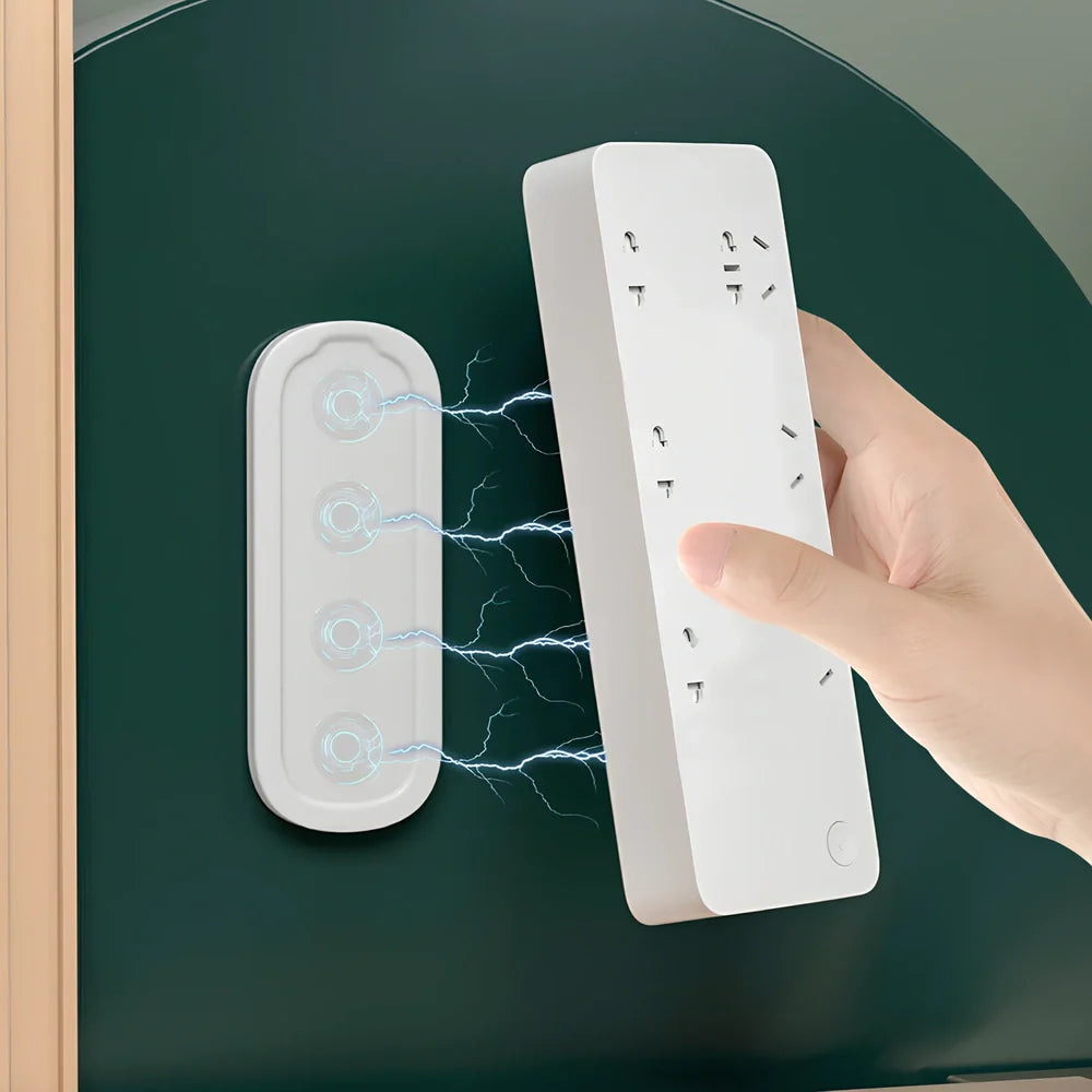 White magnetic socket organiser mounted on wall holding power board with cables organised