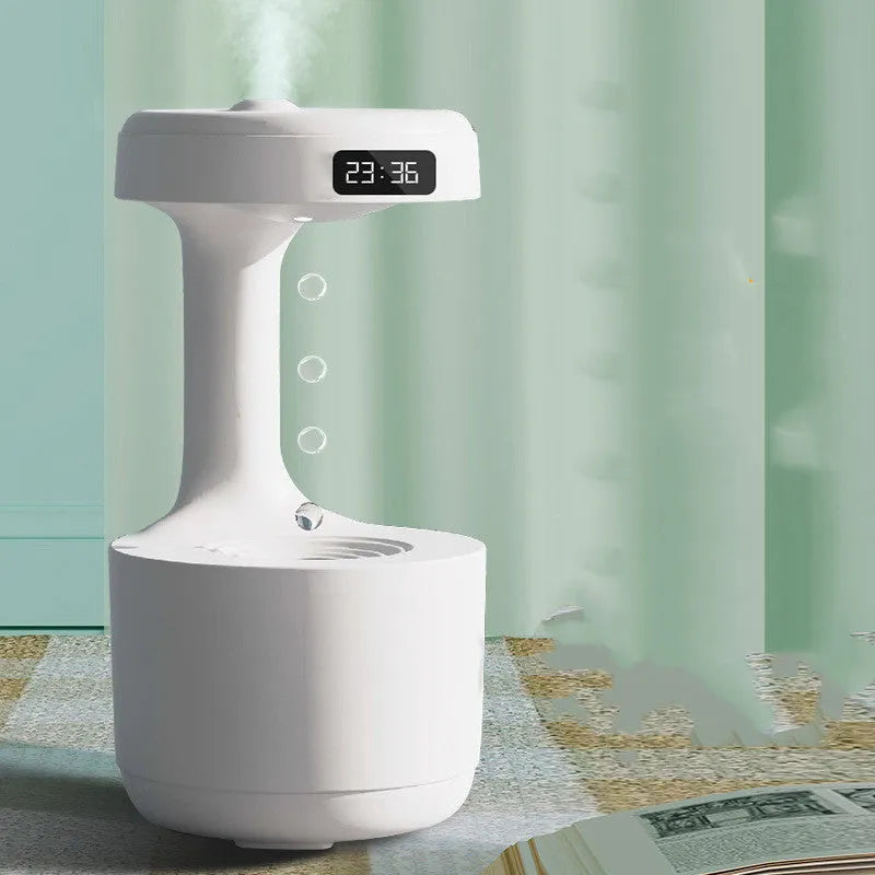 White columnar anti-gravity humidifier with LED clock display on a wooden desk