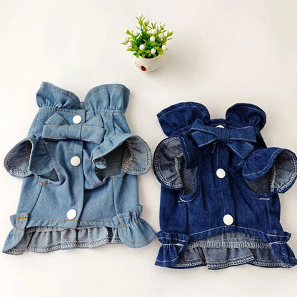 Blue denim dog dress with ruffles and integrated harness for leash attachment.
