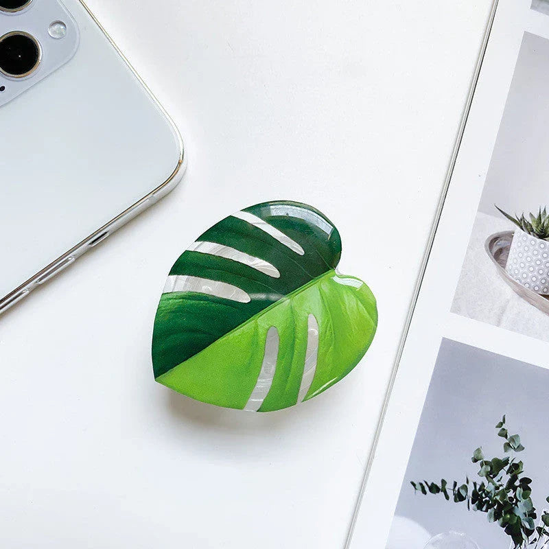 Stylish leaf-inspired smartphone stand with secure grip and adjustable viewing angle for hands-free use