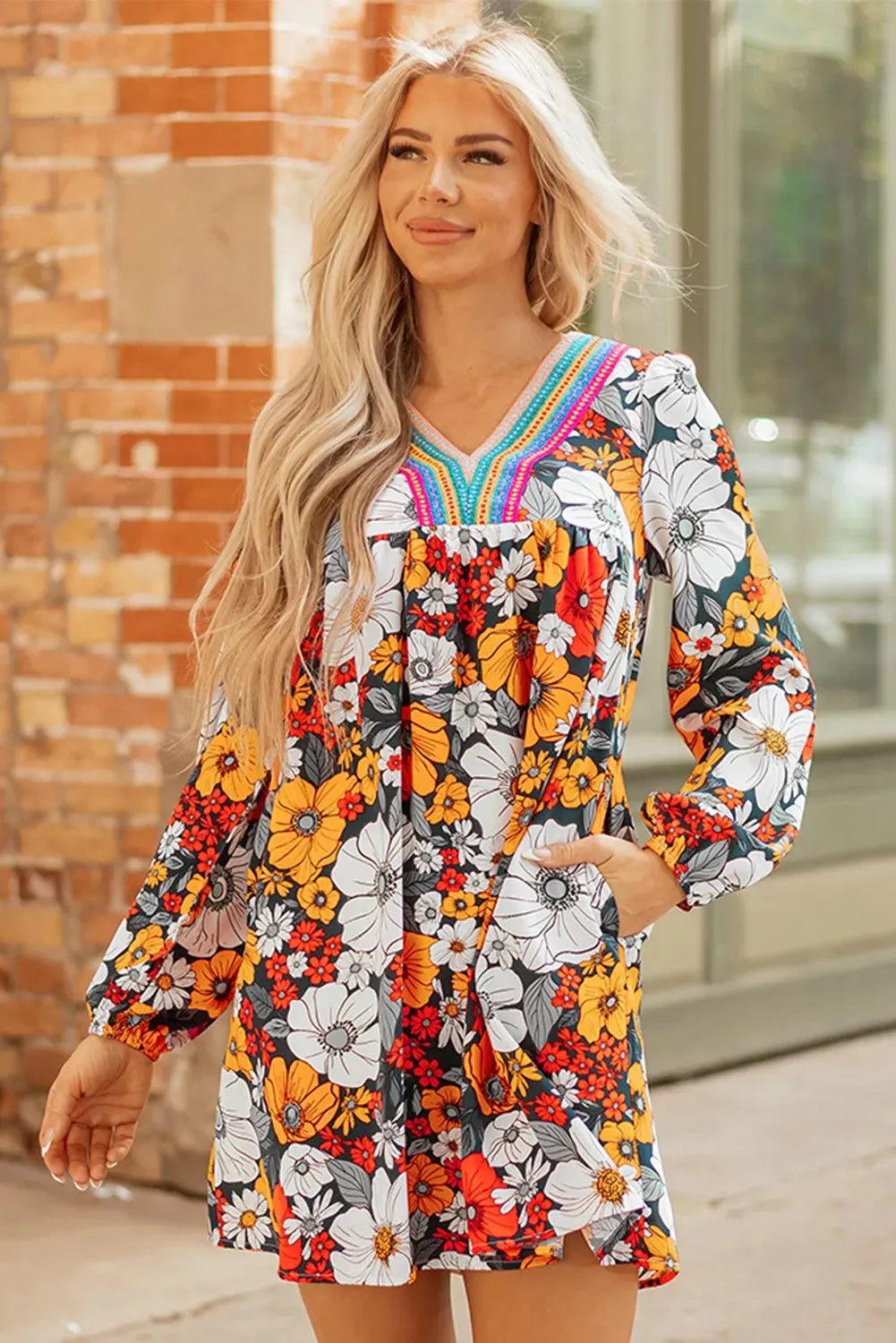 Orange floral print mini dress with striped lace detailing, V-neck collar, and long sleeves