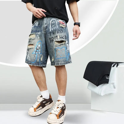 Blue denim men's shorts with ripped knees and graffiti design, featuring a straight leg and zipper fly.