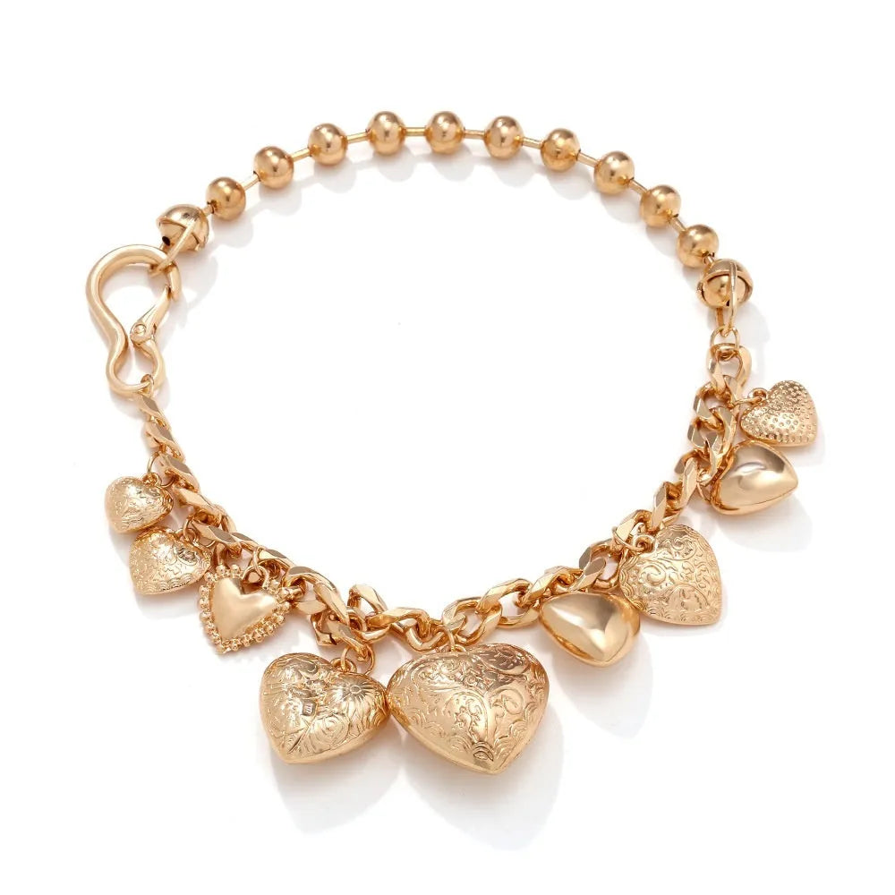 Gold carved heart pendant necklace on adjustable chain, showing exaggerated shape and textured details