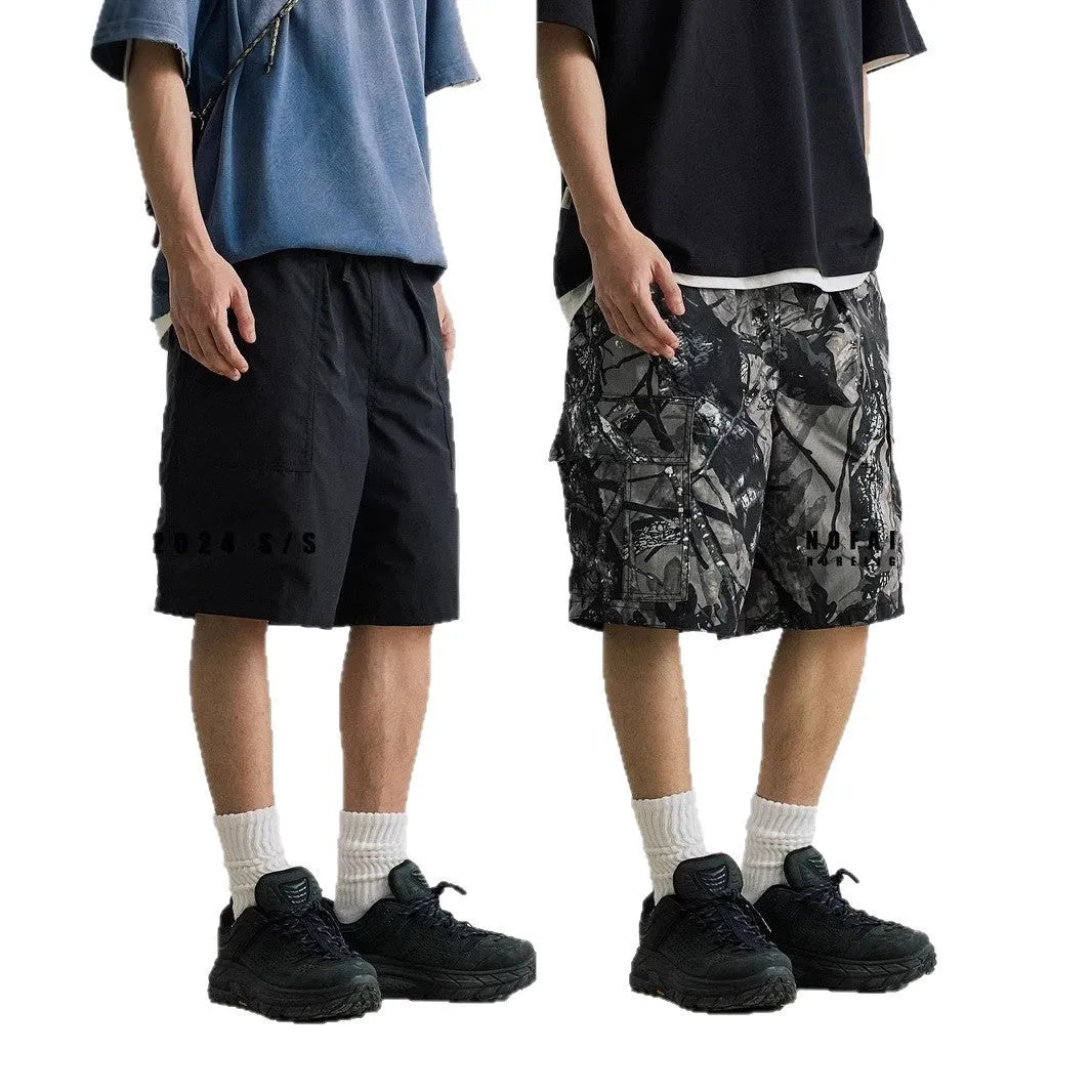 Loose straight-leg denim shorts for teenagers in army green, showing elastic waistband and zip fly.