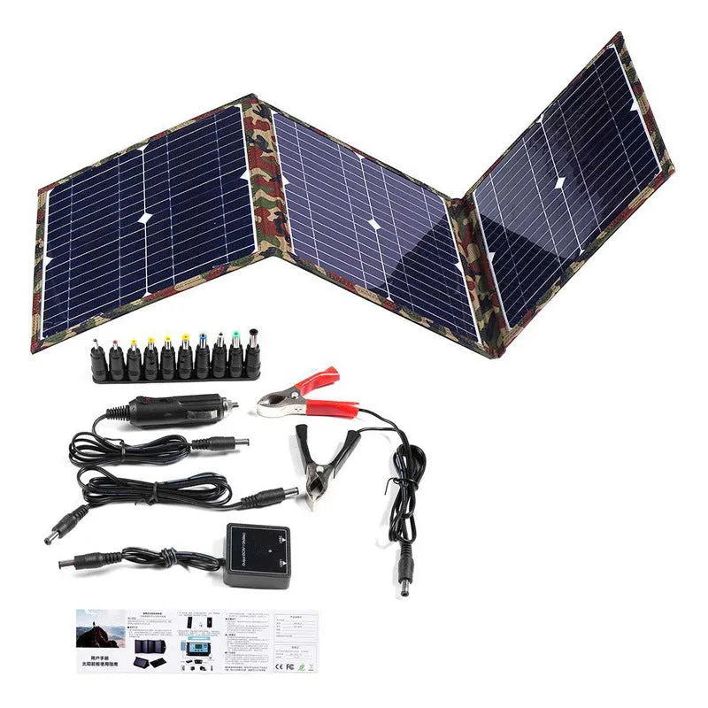 Black foldable portable solar panel unfolded showing solar cells, with included car charger and USB adapter.