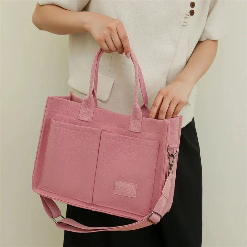 Premium canvas tote bag in multiple colors with adjustable shoulder strap and organizational pockets