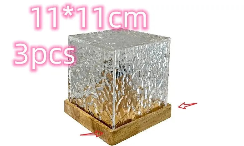 LED water ripple projection night light with remote control on wooden base showing colourful light patterns