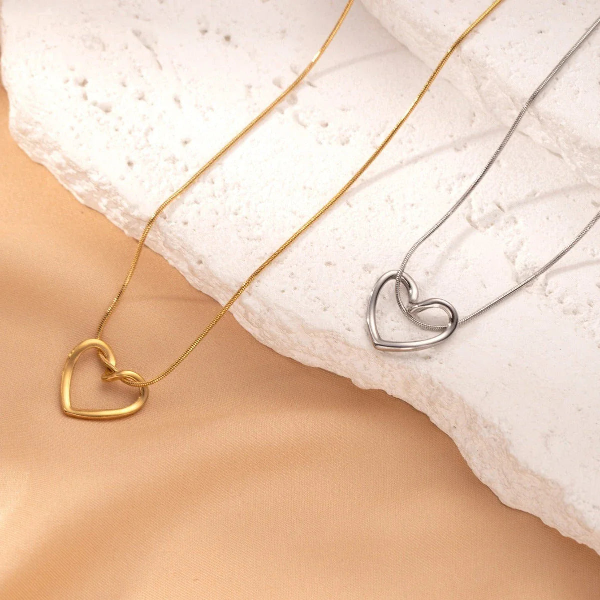 Stylish titanium steel heart pendant necklace with unique twist design, available in gold and silver colors