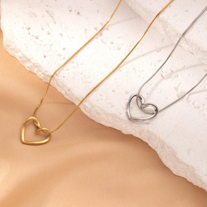 Stylish titanium steel heart pendant necklace with unique twist design, available in gold and silver colors