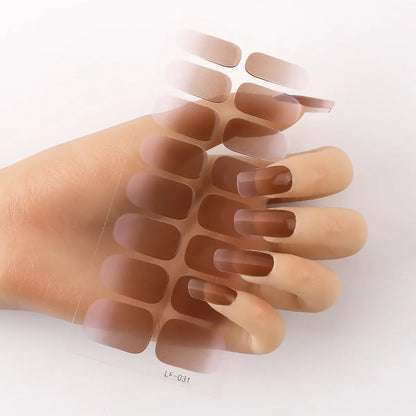 Sheet of 16 small design nail art stickers including cross, rose, tulip and marble patterns.