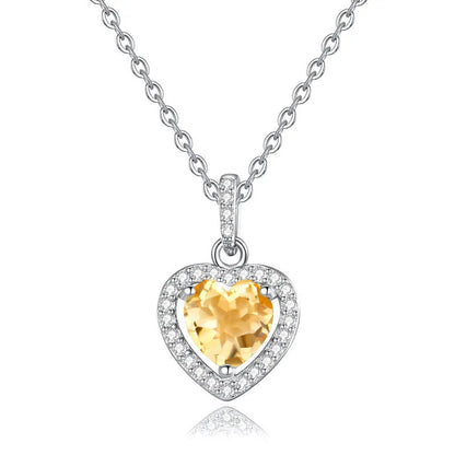 Sterling silver heart pendant necklace with a coloured gemstone on an adjustable chain.