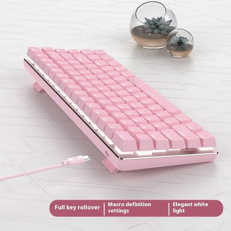 Pink mechanical keyboard with 82 keys and white backlight illumination on a desk.