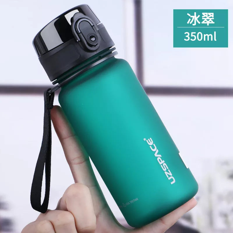 Large capacity Tritan sports water bottle in vibrant colors, perfect for hydration on the go
