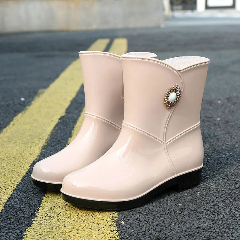Women's purple PVC rain boot with non-slip sole on a wet surface.