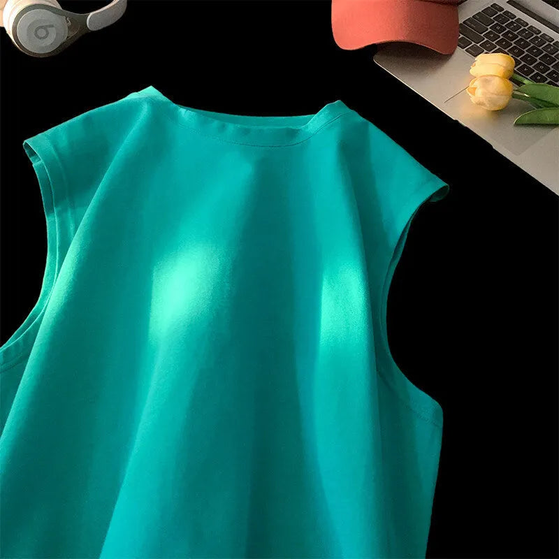 Men's loose solid colour cotton sleeveless tank top on a hanger.
