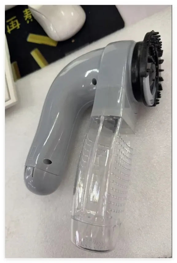 Grey portable pet hair vacuum cleaner with soft rubber head for grooming cats and dogs.