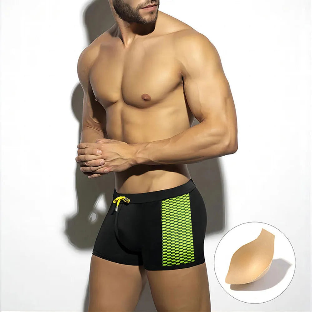 Men's yellow and black polka dot print swim boxers with a 3D cup on a plain background