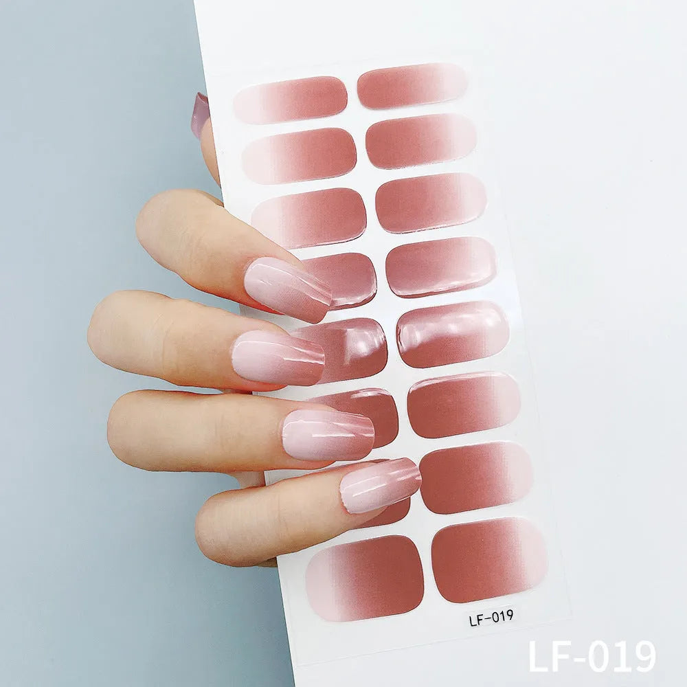 Sheet of 16 small design nail art stickers including cross, rose, tulip and marble patterns.