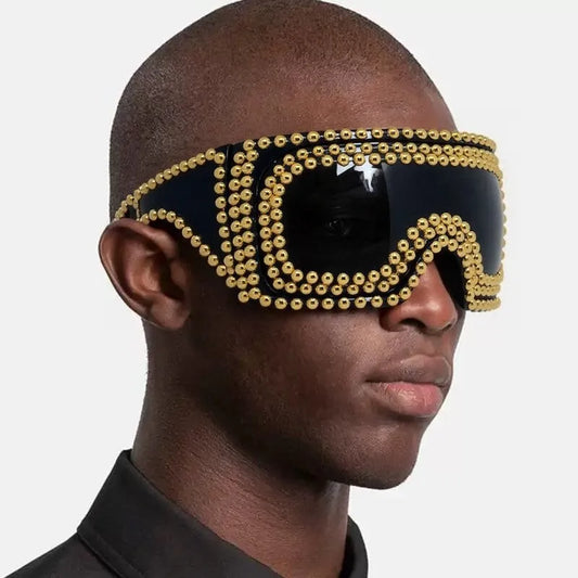 Square punk sunglasses with large rim and rivet detailing in gold colour