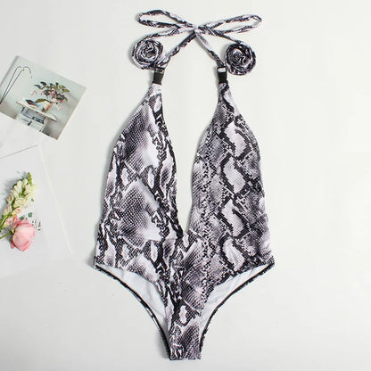 Backless leopard print one-piece swimsuit for women with a front buckle and bandage style design.