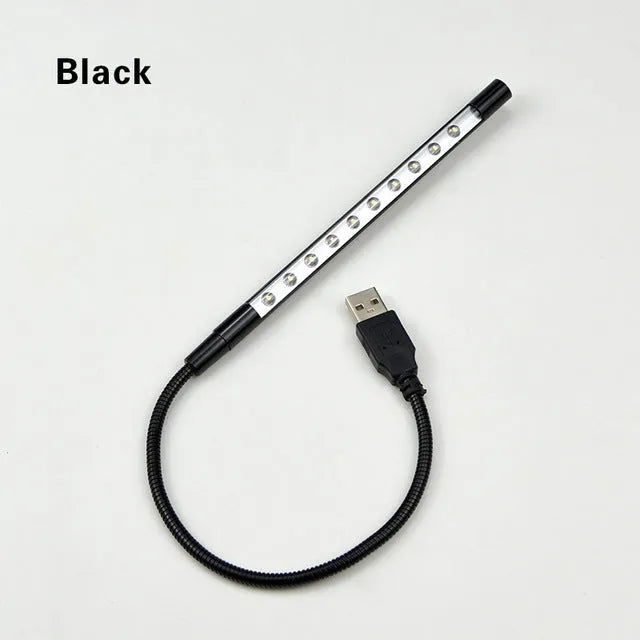 Spiral-shaped silver aluminium alloy USB LED desk lamp on a wooden table.