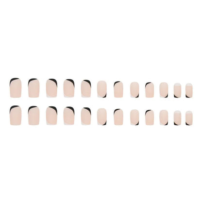 Set of 24 black and white frosted French tip fake nails with matte finish, laid out in size order.