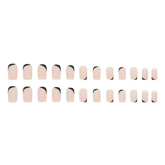 Set of 24 black and white frosted French tip fake nails with matte finish, laid out in size order.