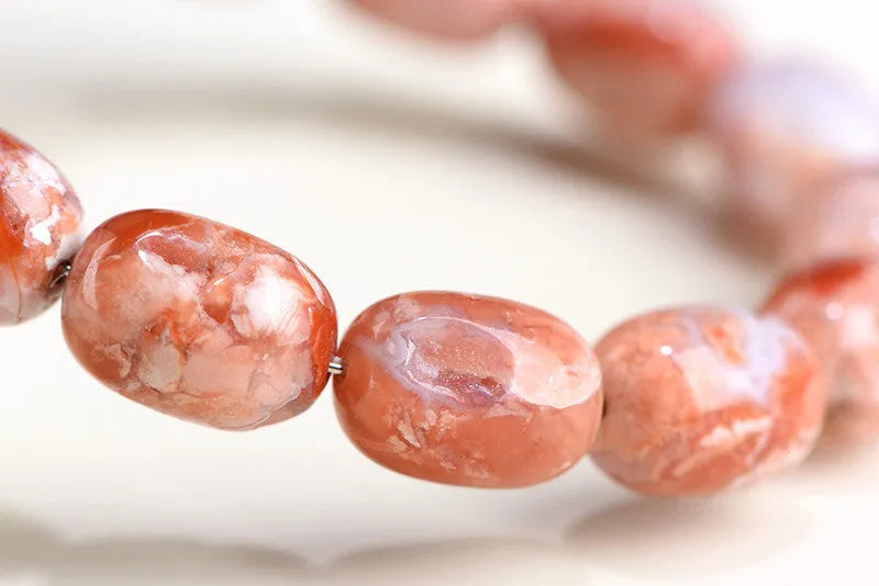 Natural cherry agate barrel bead bracelet with 10x14mm geometry design and Ruyi elements on wrist