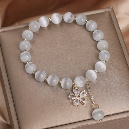 White cat's eye crystal women's bracelet with floral tassels and adjustable safety buckle clasp