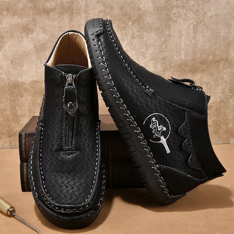 Men's slip-on loafers in black with round toe and sewing thread details, showing rubber sole