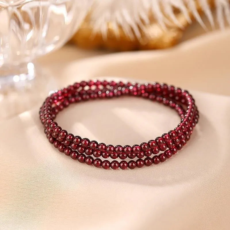 Handmade antique Chinese style bracelet with red imitation garnet and pomegranate design in a gift box.