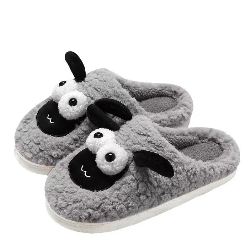 Brown suede slip-on slippers with thermal cotton body and sewn PVC sole on a wooden floor.