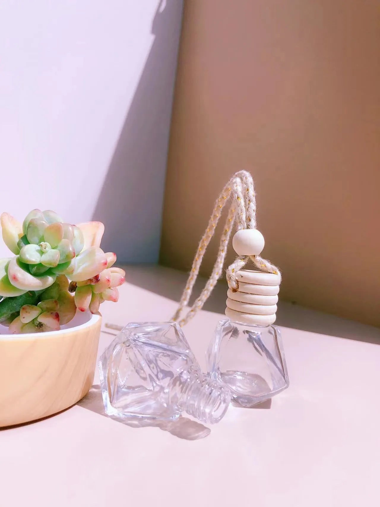 Car perfume pendant in four glass bottle styles: cylinder, diamond, flat drum, and square