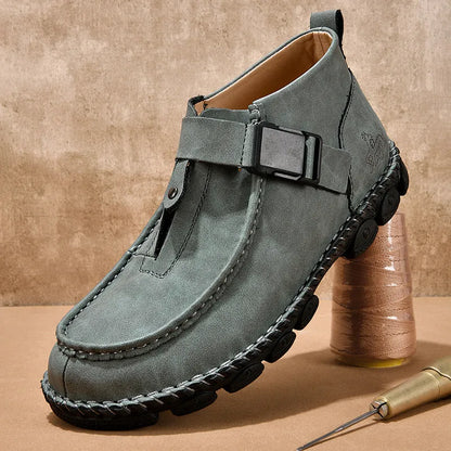 Casual flat bottom slip on shoes in brown with visible handmade sole stitching on a wooden floor.
