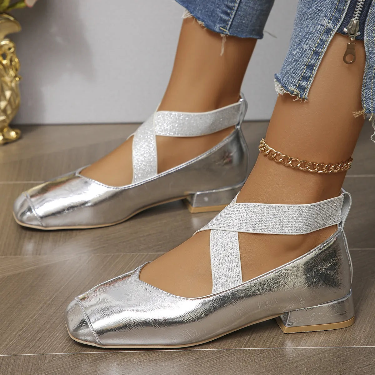 Women's gold slip-on square-toe evening pump with a low rubber heel, shown as a reusable overshoe.