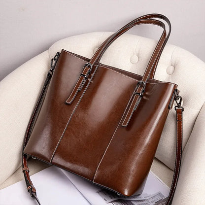 Brown genuine leather women's retro shoulder bag showing front view and organised interior pockets.