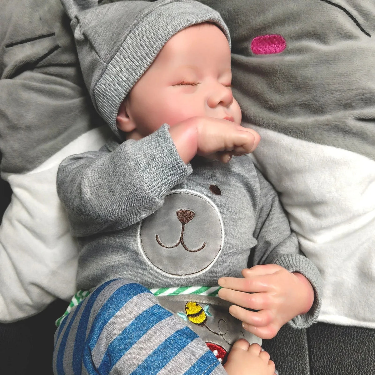 18-inch reborn doll with cloth body and hand-painted vinyl head wearing pink romper