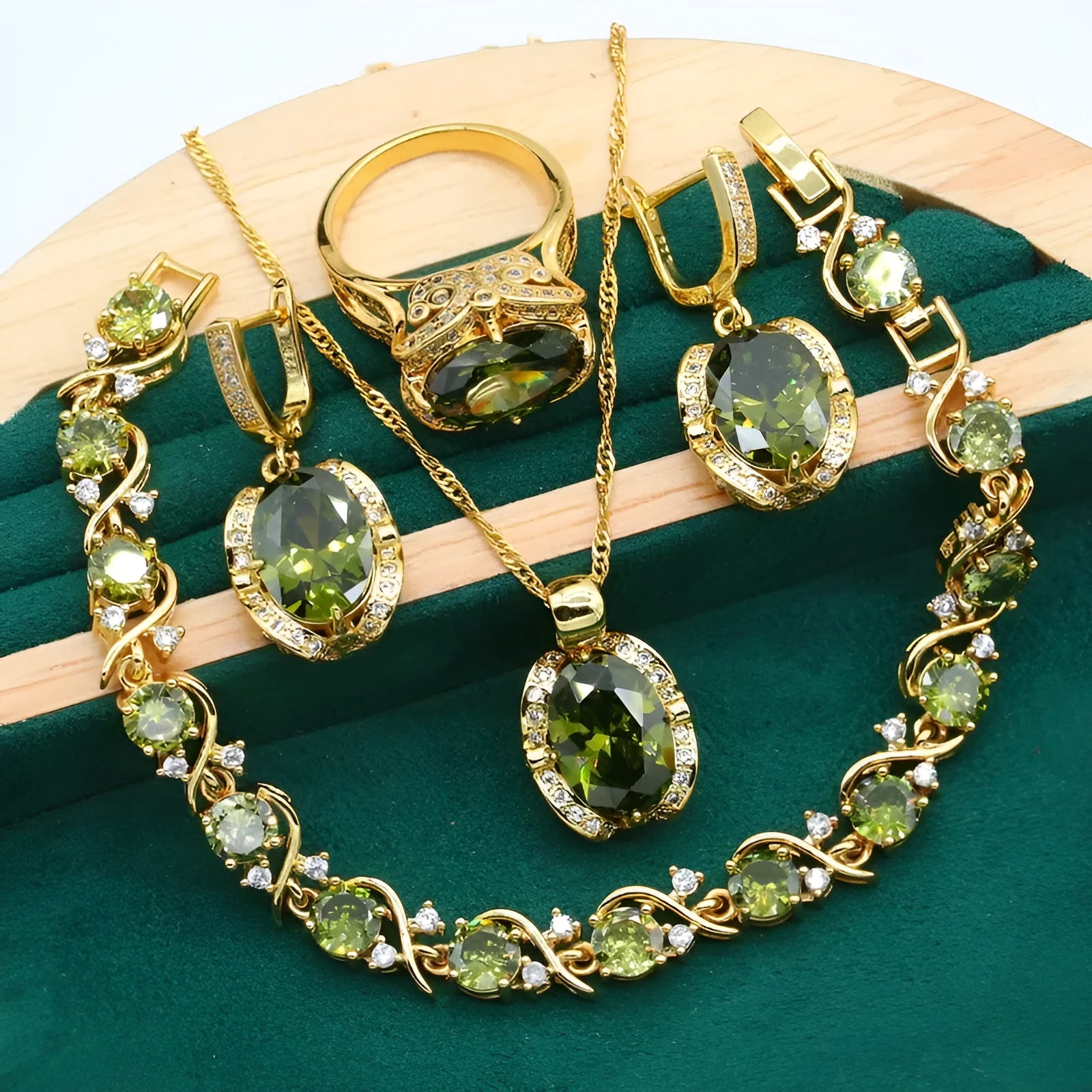 Olive green zircon jewellery suit set showing necklace with snake bone chain, matching earrings, and ring on a display.