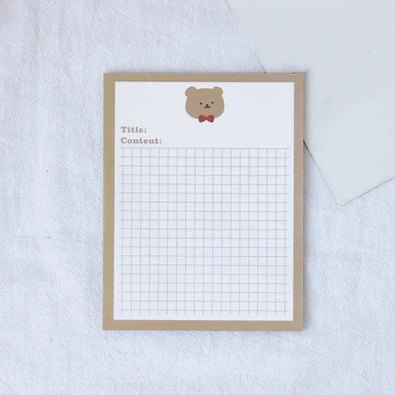 Cartoon sticky note pad in avocado or bear design, showing large and small size options next to a pen.