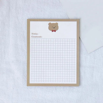 Cartoon sticky note pad in avocado or bear design, showing large and small size options next to a pen.