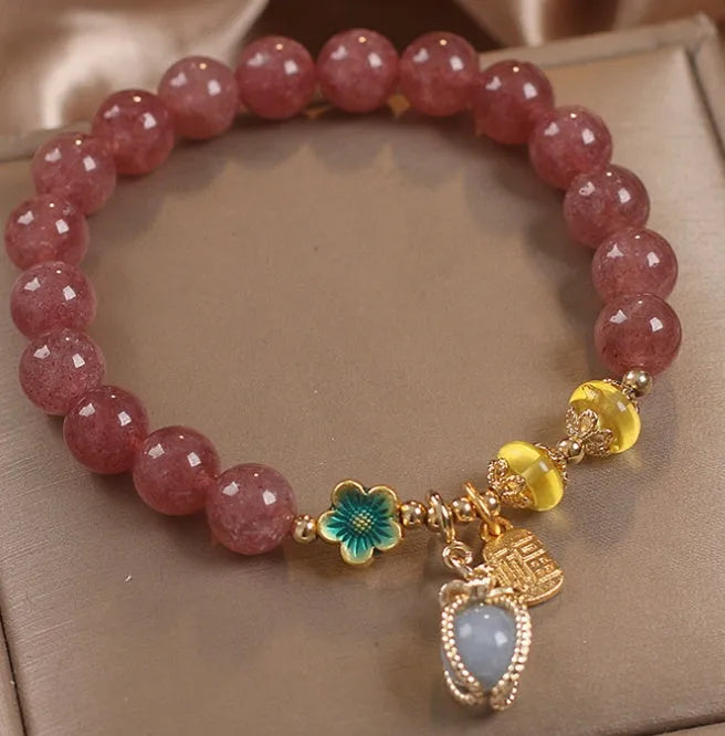 Red women's bracelet with strawberry quartz beads and rhinestones on an alloy chain.