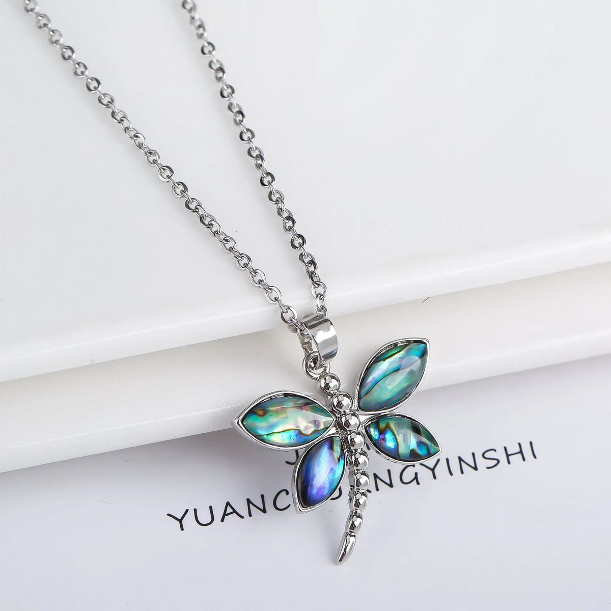 Abalone shell pendant necklace with copper electroplated animal zodiac design and butterfly or dragonfly detail