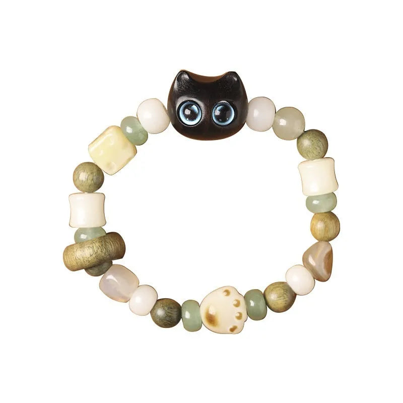 Hand-woven multi-treasure bracelet with jade, bodhi and ebony wood beads and a cartoon cat's paw charm.
