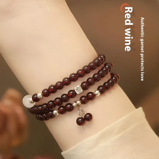 Handmade antique Chinese style bracelet with red imitation garnet and pomegranate design in a gift box.