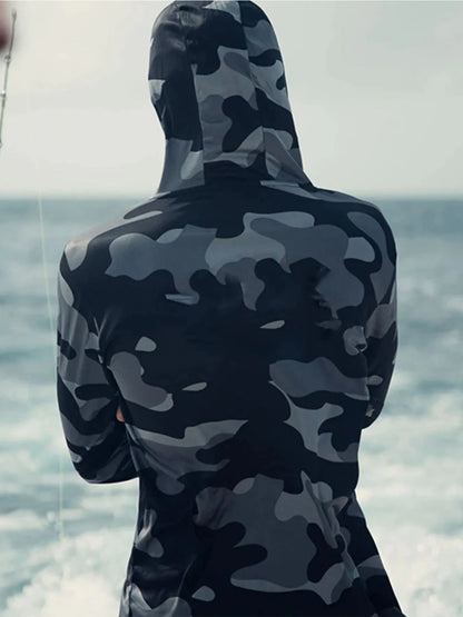 Huk Pursuit long sleeve fishing shirt with mesh side panels and crew neck, shown in an outdoor setting