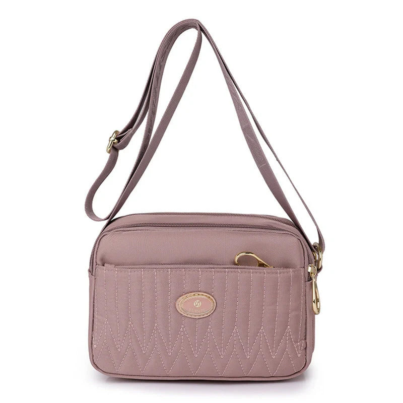 Casual women's crossbody messenger bag in nylon with polyester lining, available in multiple colors