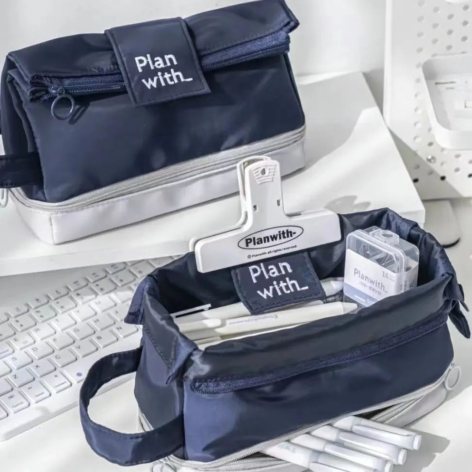 Double-layer folding pencil case showing navy blue colour with pens organised in separate compartments