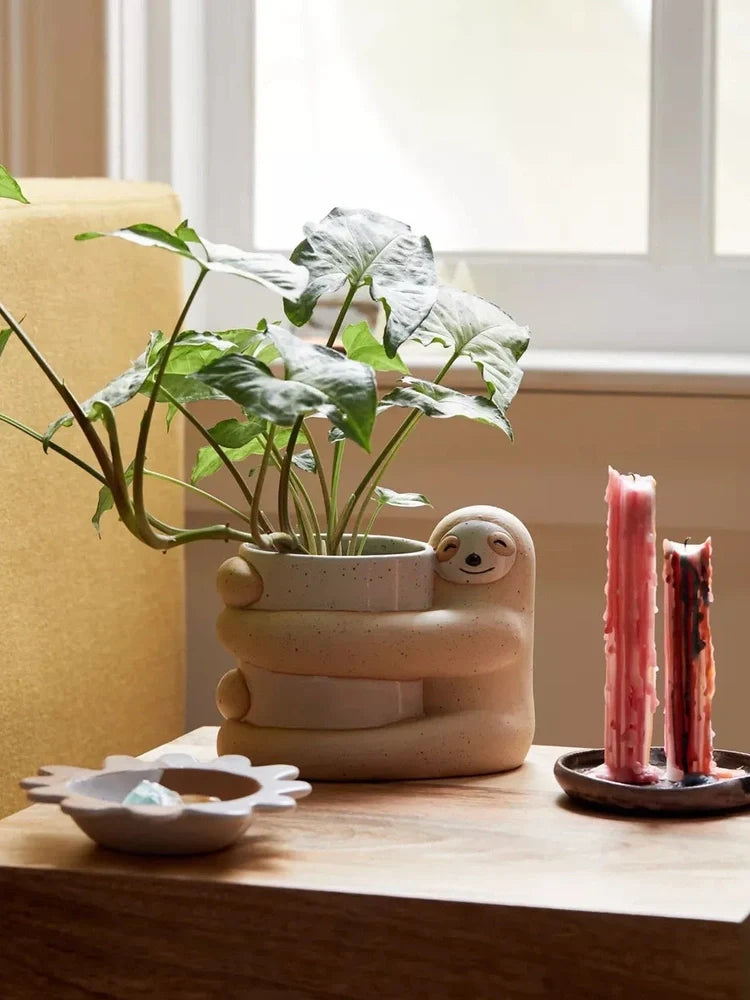 Ceramic sloth flower pot with drainage holes measuring 13.5cm height