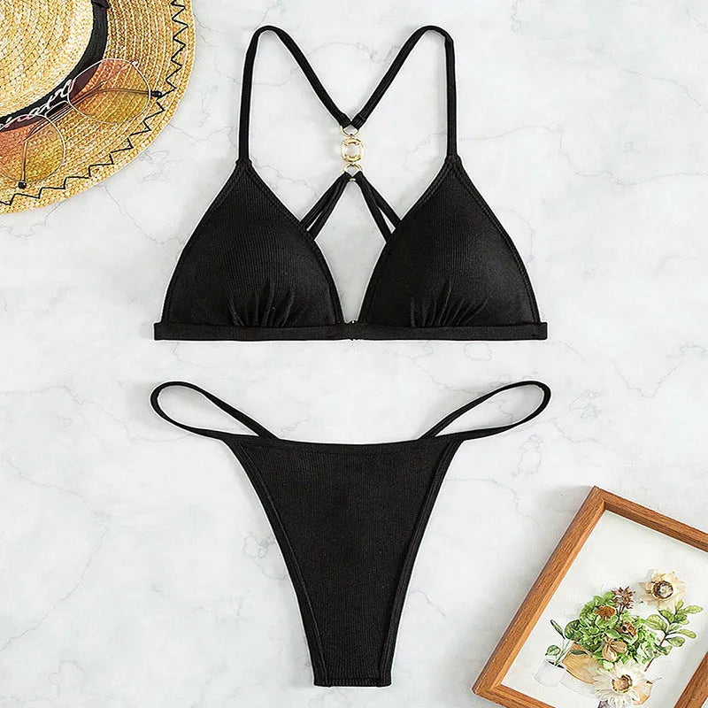Black women's hollow backless split triangle top bikini with high-cut panties on a mannequin.